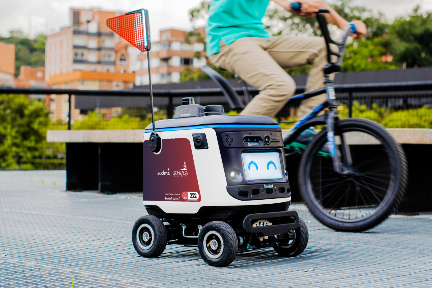A white, four-wheeled, autonomous delivery robot with a smiling face by Kiwibot.