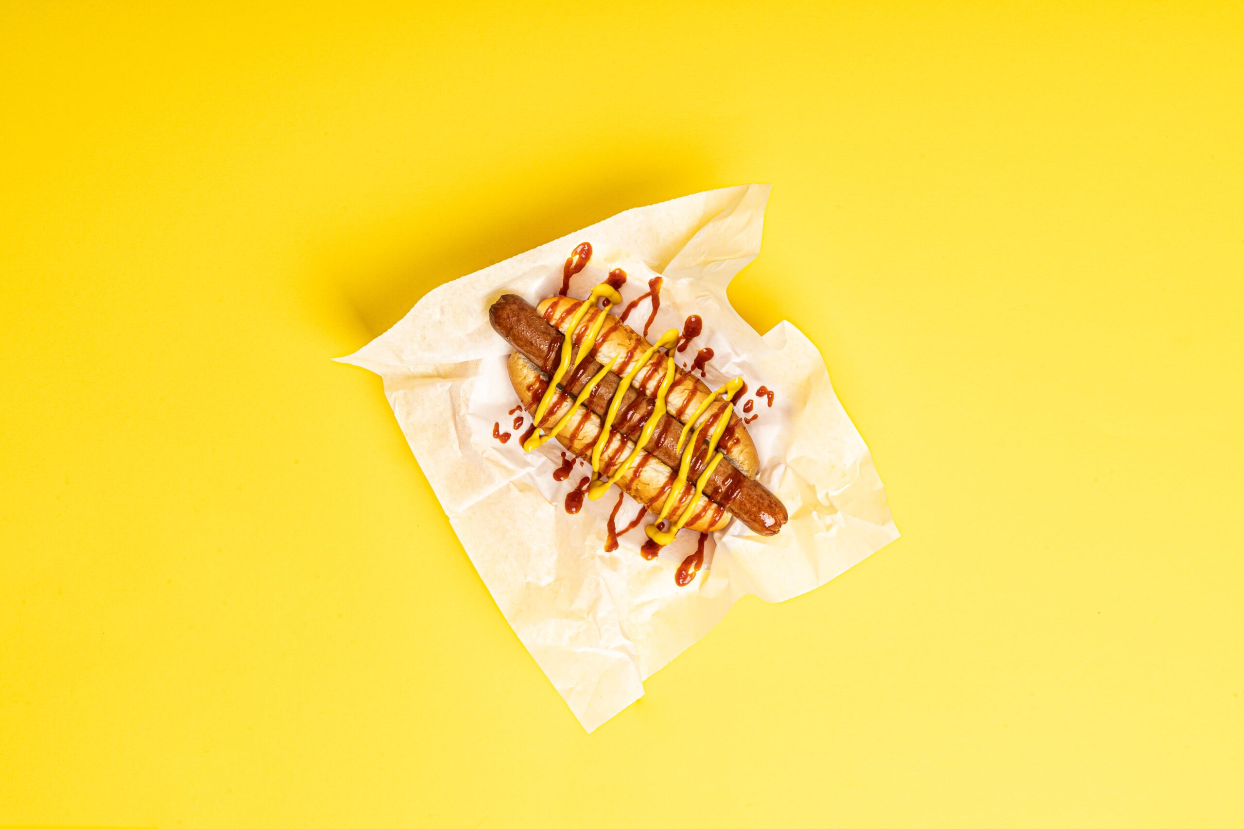 Image of Hotdog on a Yellow Background