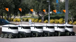 A row of 6 autonomous delivery robots by Starship Technologies.